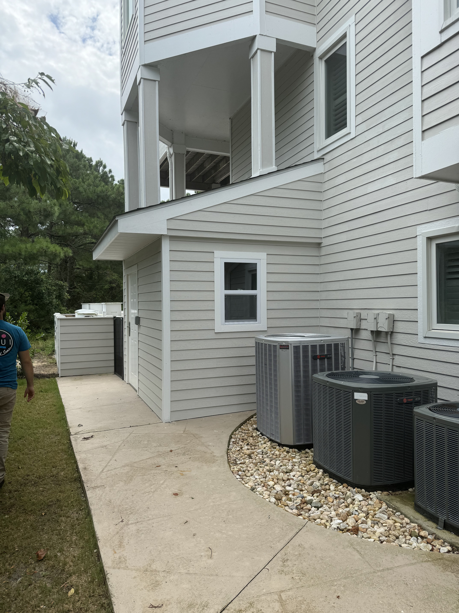 Finished house exterior design reference showing clean siding, large windows and outdoor living space